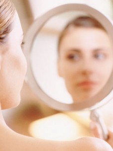 a woman who is looking at her self image-in-mirror