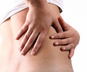 a woman who is experiencing chronic back-pain